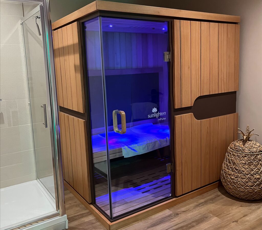 an infrared sauna for two people in a room with a shower at Aqua-Tox Wellness Clinic Hertford, Hertfordshire
