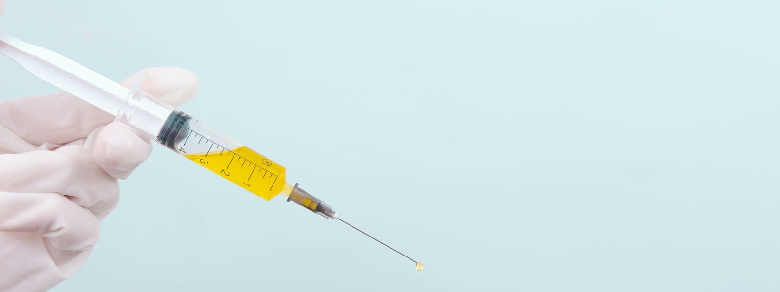 an image of a syringe filled with yellow lemon bottle solution