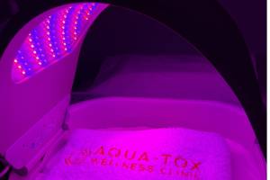 a dermalux flex led light glowing a pink colour