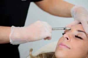 a female forehead is injected